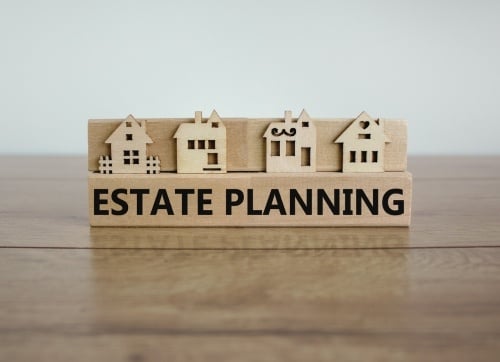 Copy of Retire in Style - Estate Planning written on a timber block with four timber cut houses