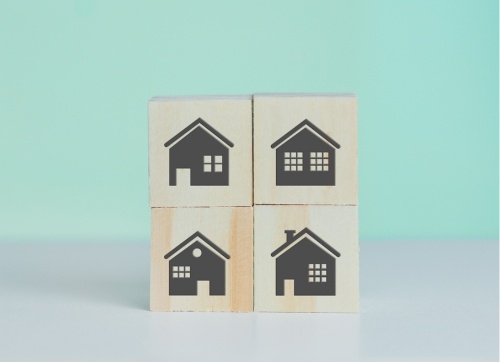 Four timber blocks in rows of two with houses stamped on them